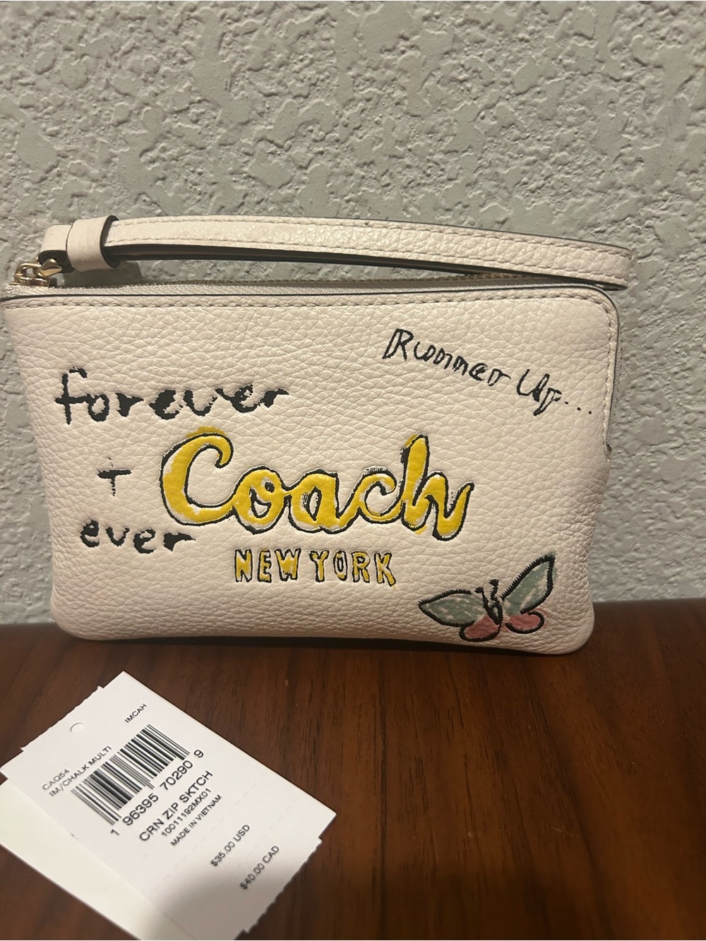 Coach White Zip Sketch Wristlet with Yellow Logo and Butterfly Accent